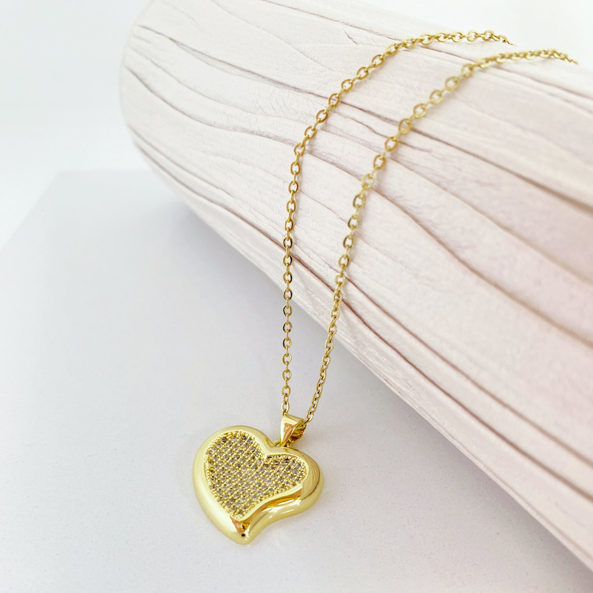 Com um design minimalista e moderno, este pendente em formato de coração é o equilíbrio perfeito entre simplicidade e glamour. Os detalhes cravejados adicionam um toque de brilho, tornando-o uma escolha versátil para qualquer ocasião.