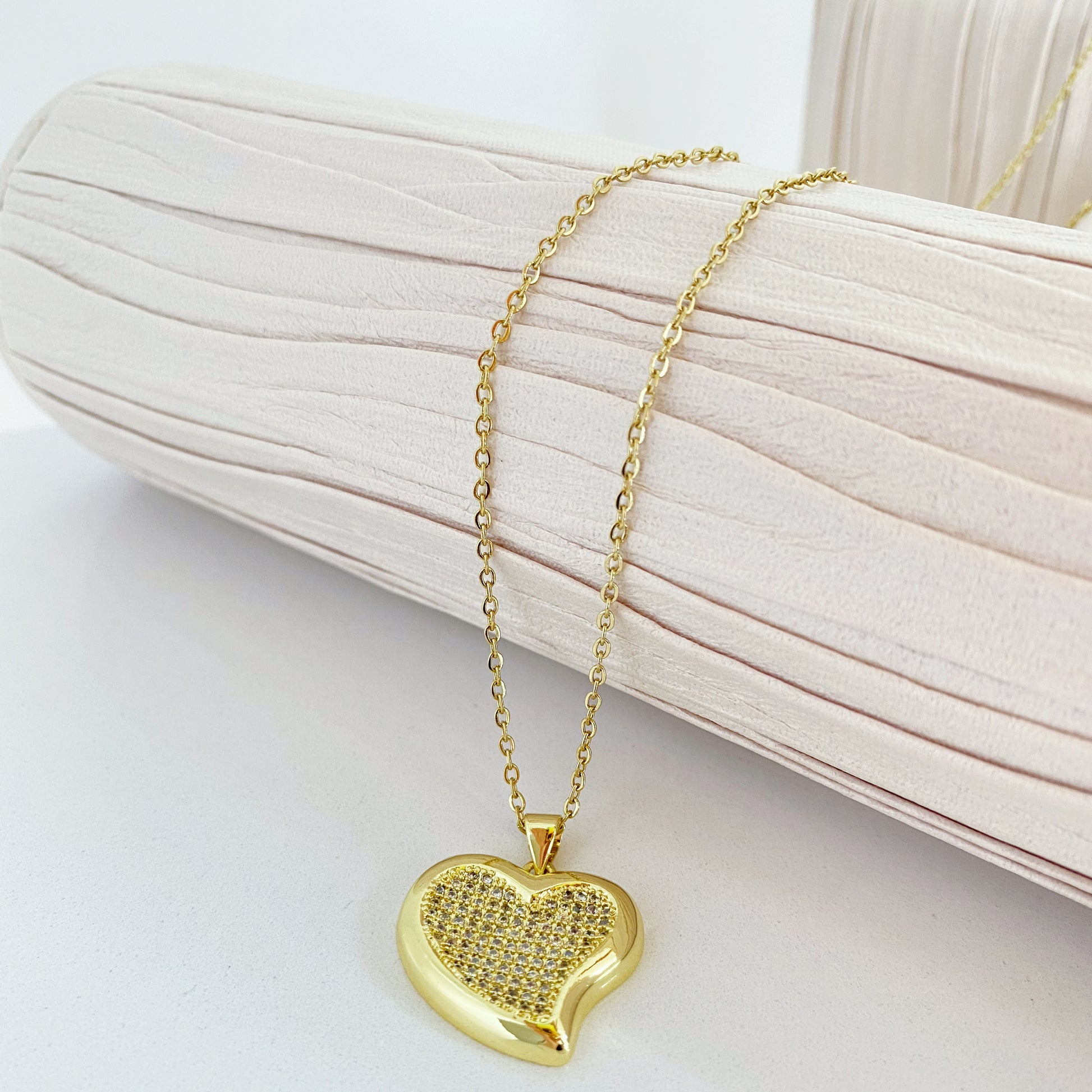 Com um design minimalista e moderno, este pendente em formato de coração é o equilíbrio perfeito entre simplicidade e glamour. Os detalhes cravejados adicionam um toque de brilho, tornando-o uma escolha versátil para qualquer ocasião.